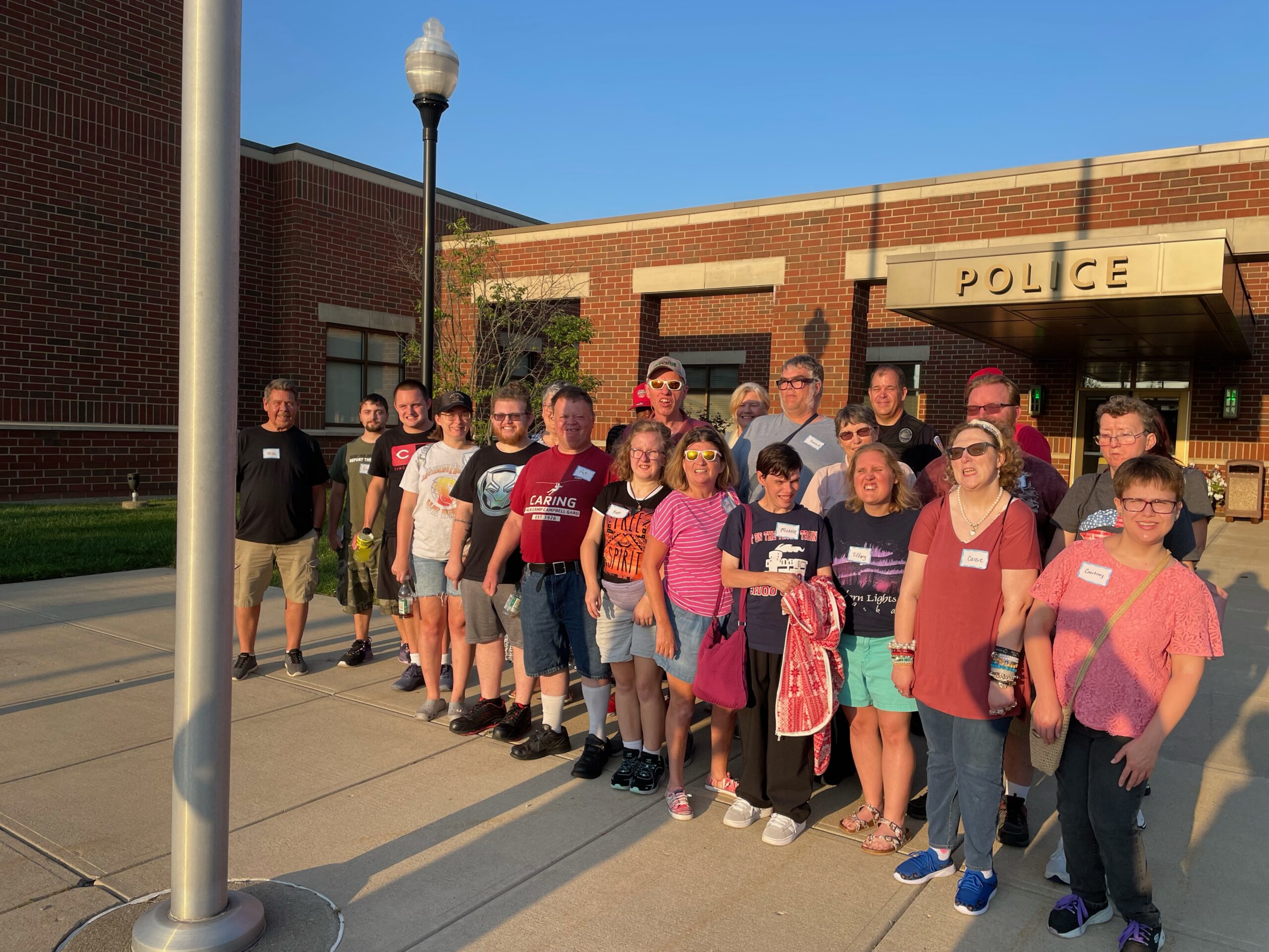 A large group of people standing outdoors in front of the Fairfield Police Station